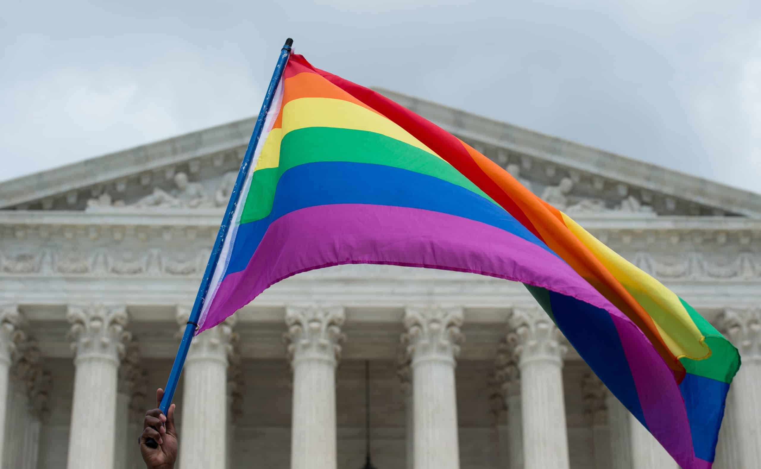 A rainbow flag is flown outside the Supreme Court in Washington, DC on June 26, 2015 after its historic decision on gay marriage. The US Supreme Court ruled that gay marriage is a nationwide right, a landmark decision in one of the most keenly awaited announcements in decades and sparking scenes of jubilation. The nation's highest court, in a narrow 5-4 decision, said the US Constitution requires all states to carry out and recognize marriage between people of the same sex. AFP PHOTO/ MOLLY RILEY (Photo by MOLLY RILEY / AFP)        (Photo credit should read MOLLY RILEY/AFP/Getty Images)